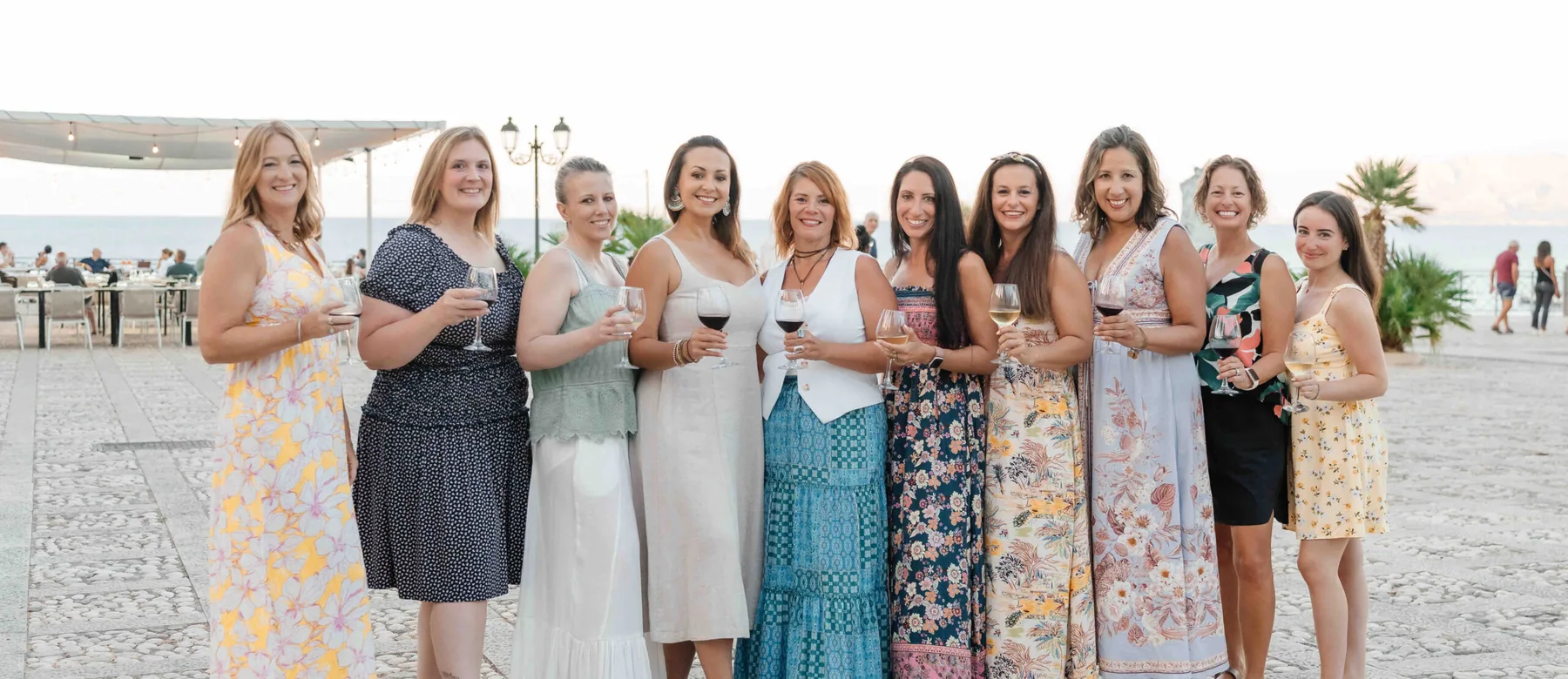 The Sicily retreat group lined up together on the promenade at sunset